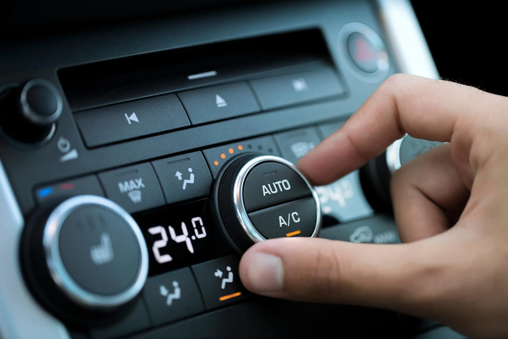 Close-up of car air conditioning control knob set to 24 degrees in Singapore vehicle