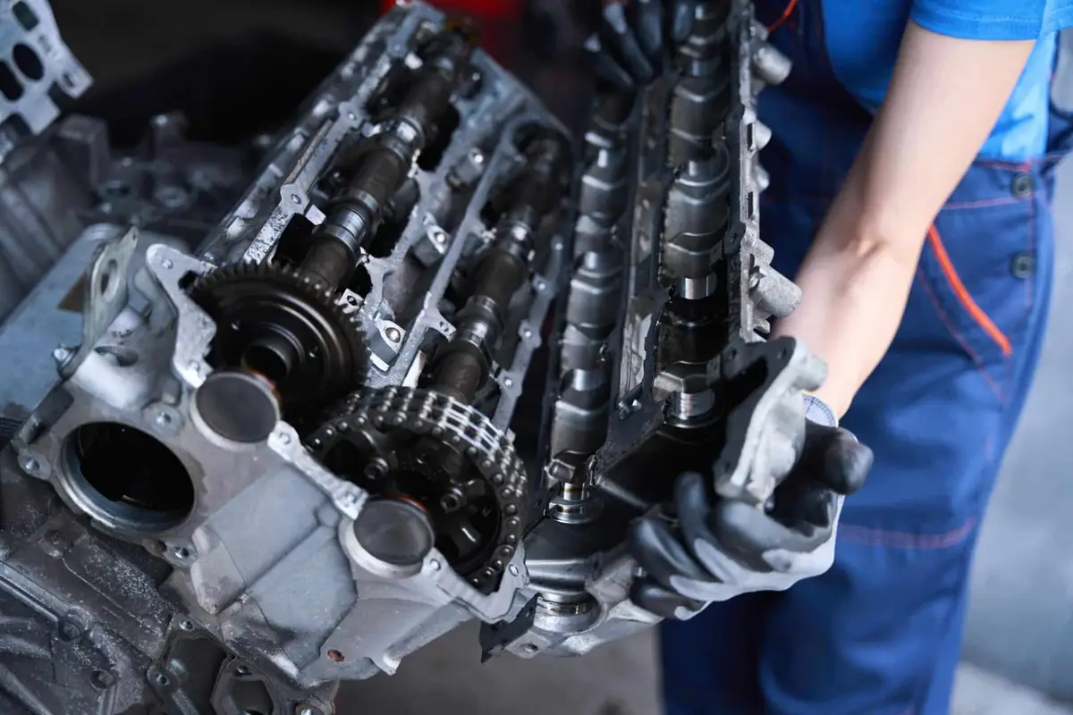 Mechanic disassembling car engine for repair in Singapore workshop